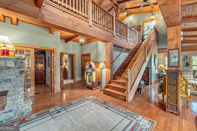 259 Eagle Chase Cir, Dillard, GA 30537 - staircase with wooden ceiling, beam ceiling, wood finished floors, baseboards, and high vaulted ceiling