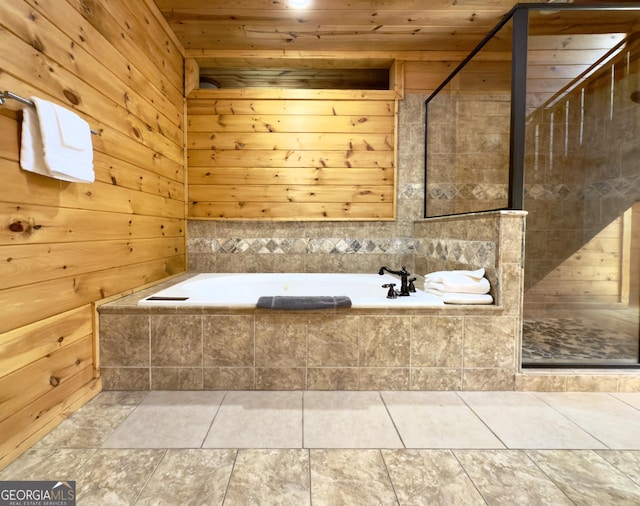 bathroom with wood walls, a garden tub, wood ceiling, a tile shower, and tile patterned flooring
