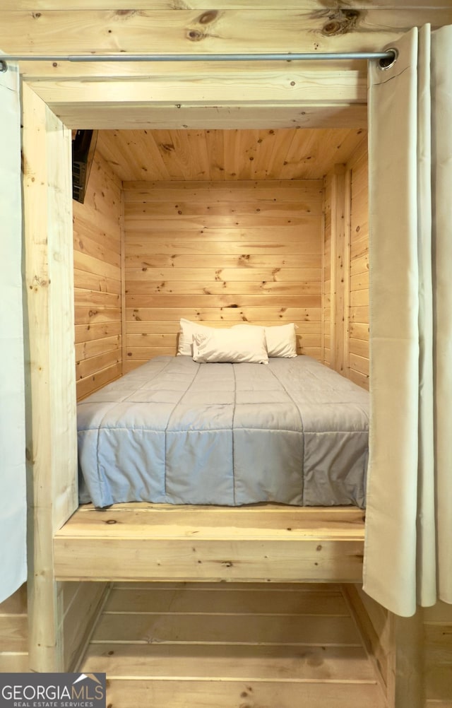 bedroom featuring wood walls and wooden ceiling