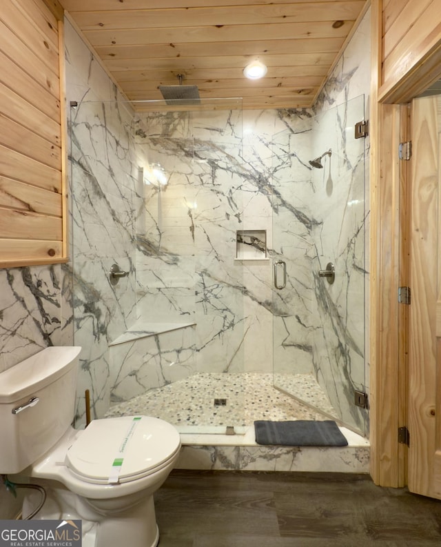 bathroom with wooden ceiling, a marble finish shower, and toilet
