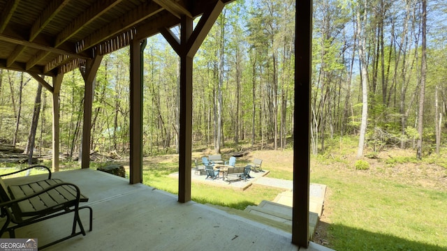view of patio with a wooded view