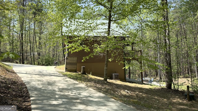view of side of property featuring central AC