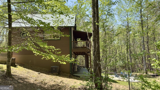 view of side of property featuring central AC