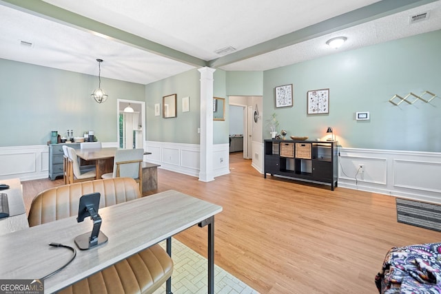 4104 Glenaire Way NW, Acworth, GA 30101 - living area with a decorative wall, a wainscoted wall, ornate columns, and light wood-type flooring