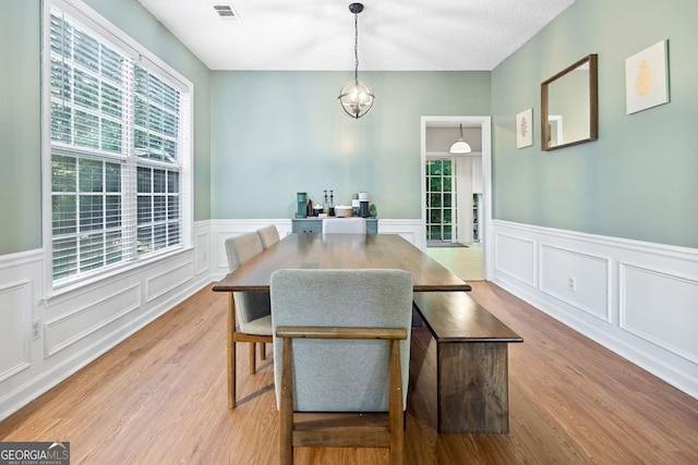 4104 Glenaire Way NW, Acworth, GA 30101 - dining area with wood finished floors, a wainscoted wall, a decorative wall, and a chandelier