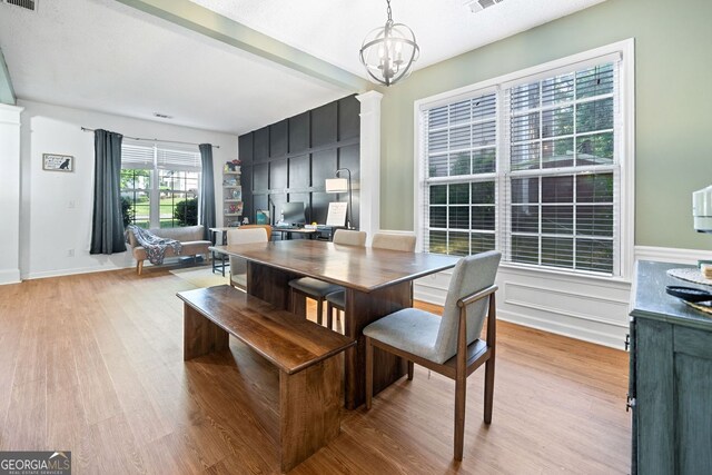 4104 Glenaire Way NW, Acworth, GA 30101 - dining area with light wood-style flooring, a chandelier, an office area, and decorative columns