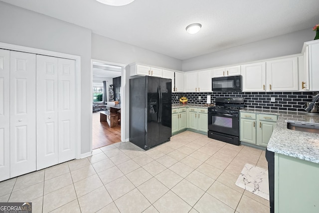 4104 Glenaire Way NW, Acworth, GA 30101 - kitchen with black appliances, decorative backsplash, light tile patterned floors, and white cabinets