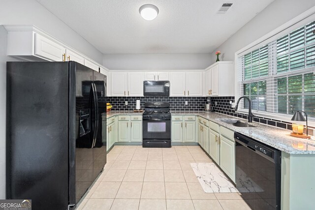 4104 Glenaire Way NW, Acworth, GA 30101 - kitchen featuring black appliances, backsplash, light tile patterned flooring, and light stone countertops