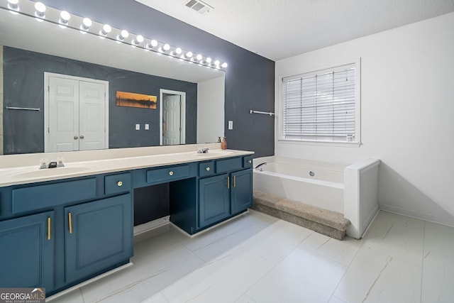 4104 Glenaire Way NW, Acworth, GA 30101 - full bath with double vanity, a garden tub, and a textured ceiling