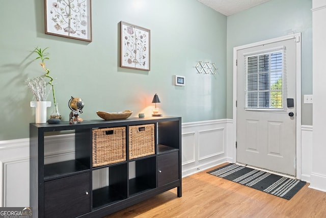 4104 Glenaire Way NW, Acworth, GA 30101 - entryway featuring wood finished floors, wainscoting, and a decorative wall