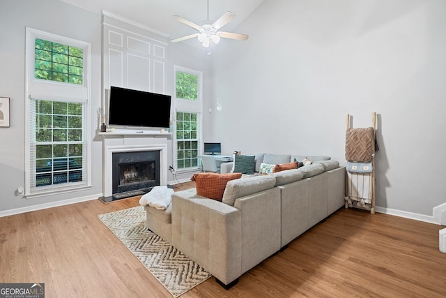 4104 Glenaire Way NW, Acworth, GA 30101 - living area with high vaulted ceiling, ceiling fan, light wood-style floors, and a fireplace with raised hearth