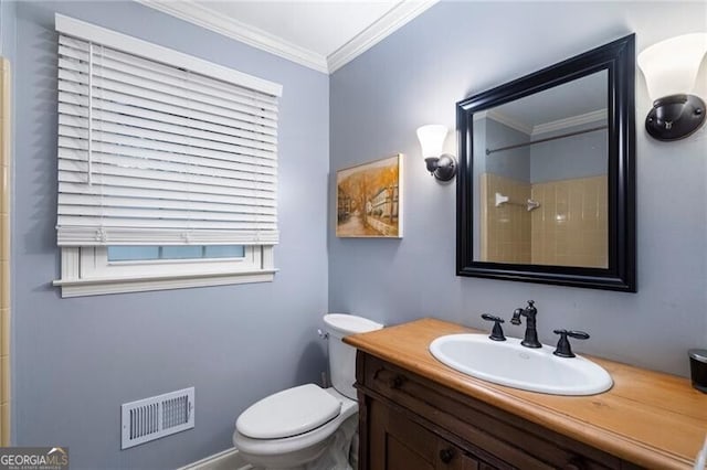 bathroom featuring crown molding, toilet, vanity, plenty of natural light, and a shower