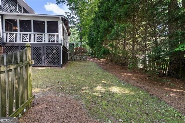 view of yard featuring a sunroom