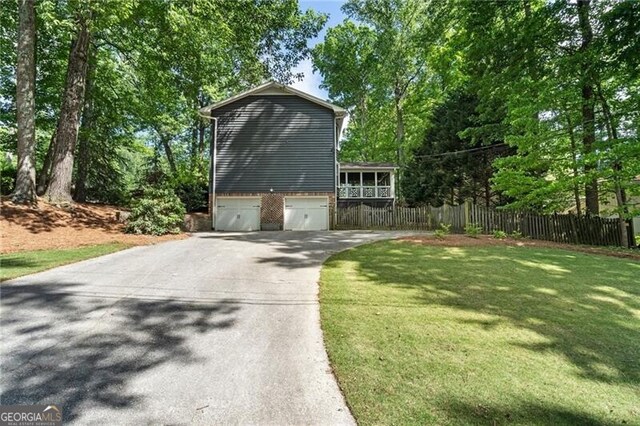 view of property exterior featuring asphalt driveway, a garage, and brick siding