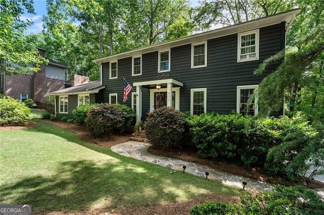 colonial-style house with a front yard
