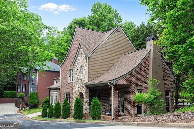 580 Cliftwood Ct, Sandy Springs, GA 30328 - view of front of house featuring roof with shingles, a chimney, and brick siding