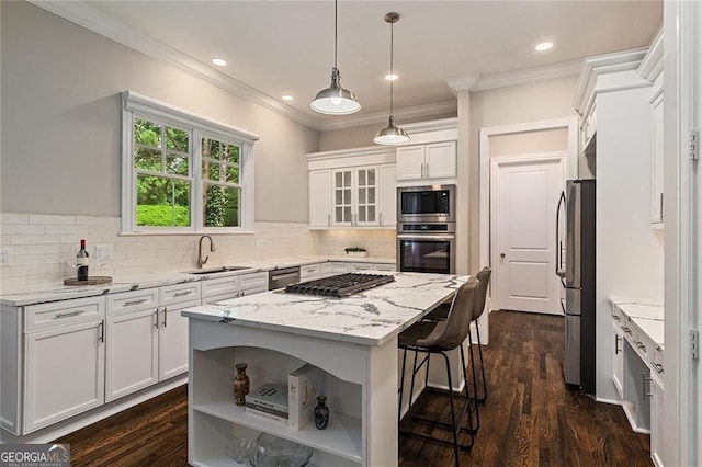 580 Cliftwood Ct, Sandy Springs, GA 30328 - kitchen featuring appliances with stainless steel finishes, a breakfast bar area, white cabinets, a center island, and open shelves