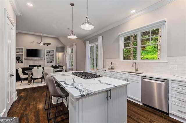 580 Cliftwood Ct, Sandy Springs, GA 30328 - kitchen featuring stainless steel appliances, crown molding, a kitchen island, light stone counters, and white cabinetry