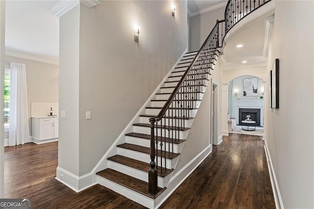 580 Cliftwood Ct, Sandy Springs, GA 30328 - stairway with arched walkways, wood finished floors, ornamental molding, a fireplace, and recessed lighting