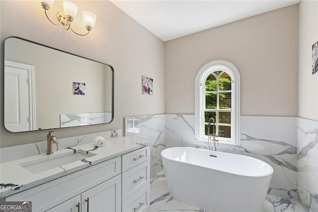 580 Cliftwood Ct, Sandy Springs, GA 30328 - bathroom with marble tiled floors, tile walls, vanity, a soaking tub, and wainscoting
