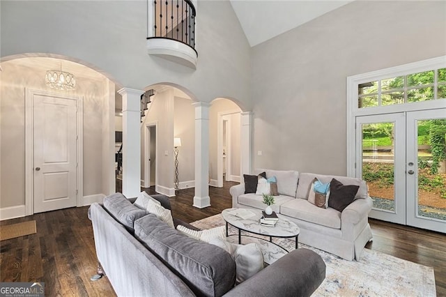 580 Cliftwood Ct, Sandy Springs, GA 30328 - living room with high vaulted ceiling, ornate columns, arched walkways, and wood finished floors