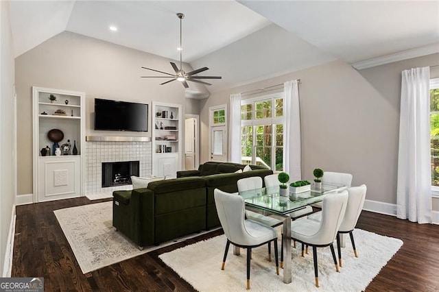 580 Cliftwood Ct, Sandy Springs, GA 30328 - dining area with lofted ceiling, plenty of natural light, a ceiling fan, a tile fireplace, and dark wood-style flooring