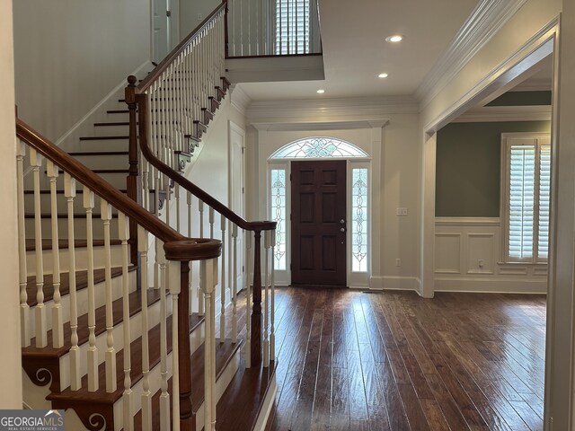 4345 Spring Branch Cir, Valdosta, GA 31601 - foyer with dark wood-style floors, crown molding, a wainscoted wall, a decorative wall, and stairs