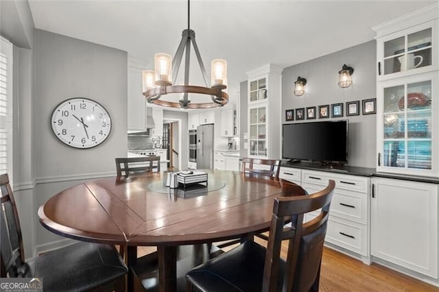 dining space with a chandelier and light wood finished floors