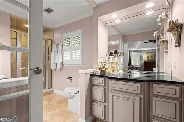 full bathroom with ornamental molding, a stall shower, toilet, baseboards, and vanity