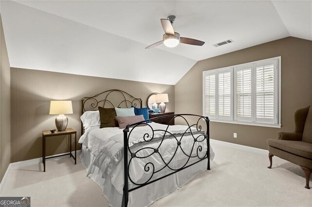 carpeted bedroom with vaulted ceiling, baseboards, and ceiling fan