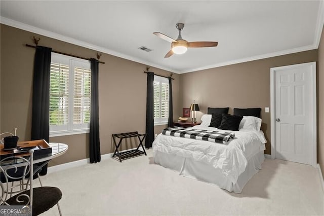 carpeted bedroom with crown molding, baseboards, and ceiling fan