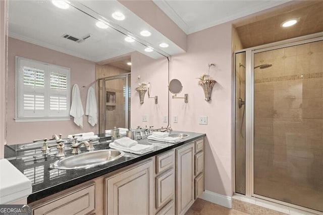bathroom featuring recessed lighting, a stall shower, ornamental molding, and double vanity