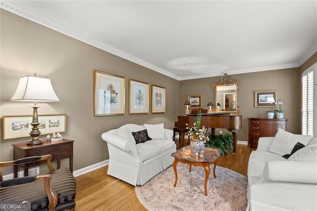 living room featuring baseboards, wood finished floors, and ornamental molding