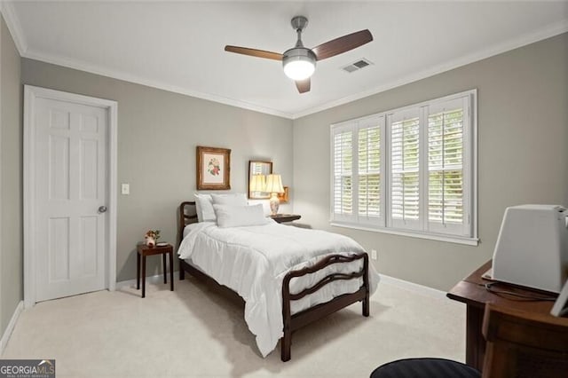 bedroom with light colored carpet, crown molding, baseboards, and ceiling fan