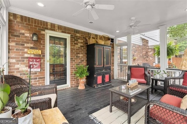 sunroom featuring ceiling fan and outdoor lounge area