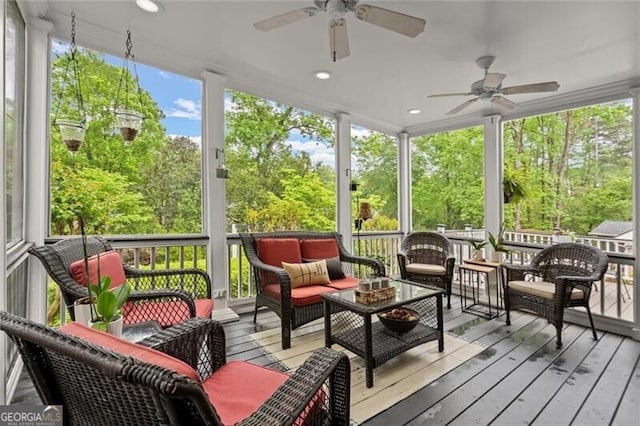 sunroom / solarium featuring ceiling fan and an outdoor living space