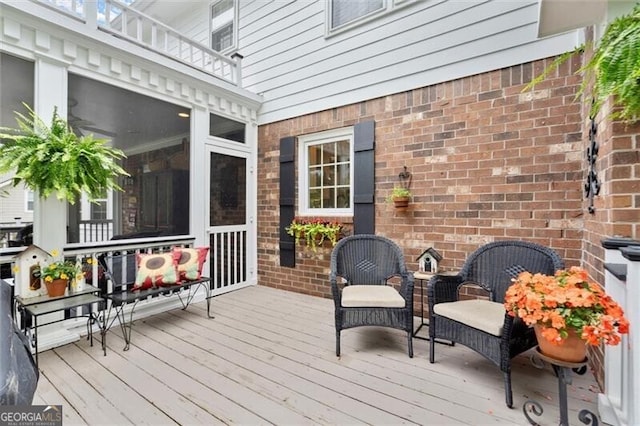 wooden deck with a sunroom