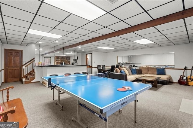 recreation room featuring carpet floors and a drop ceiling