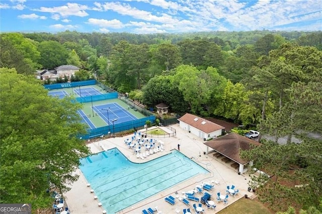 bird's eye view of a forest and a pool