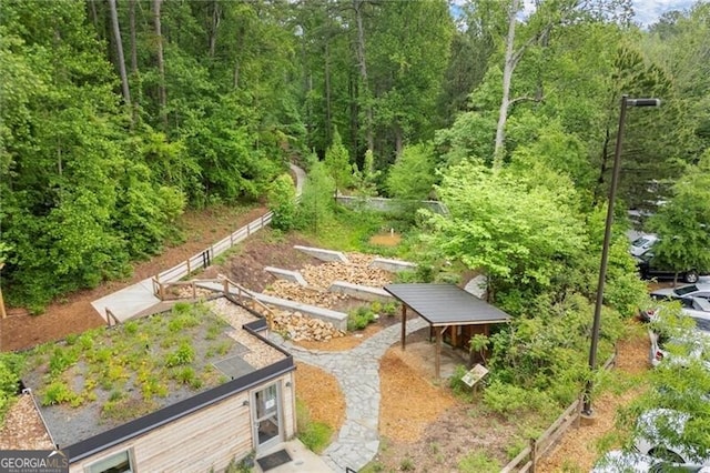 surrounding community with a wooded view and a vegetable garden