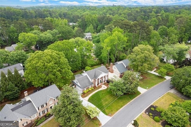 aerial perspective of suburban area featuring a heavily wooded area