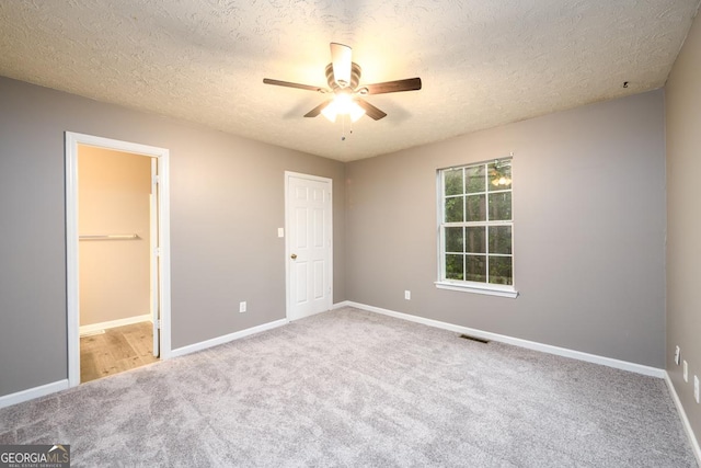 3001 Majestic Park Ct, Duluth, GA 30096 - unfurnished bedroom featuring carpet floors, a textured ceiling, baseboards, a ceiling fan, and connected bathroom