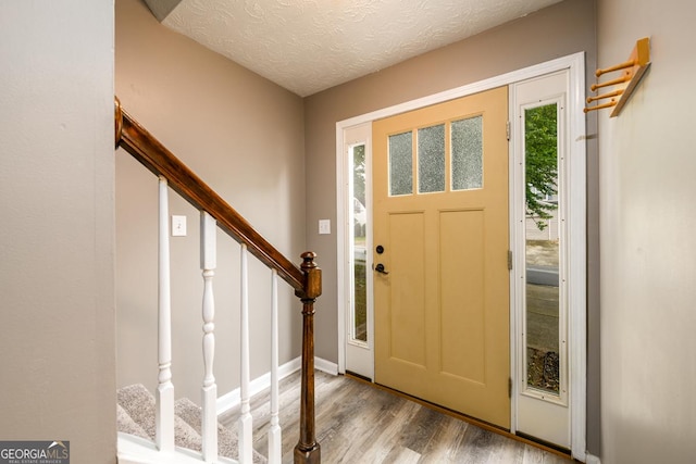 3001 Majestic Park Ct, Duluth, GA 30096 - entryway featuring wood finished floors, stairway, and a textured ceiling