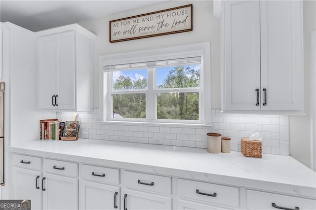 6150 Bridge Fair Rd, Cumming, GA 30028 - kitchen featuring white cabinetry, decorative backsplash, and light stone counters
