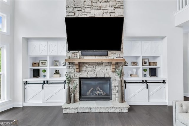 6150 Bridge Fair Rd, Cumming, GA 30028 - living area featuring dark wood finished floors, baseboards, and a stone fireplace