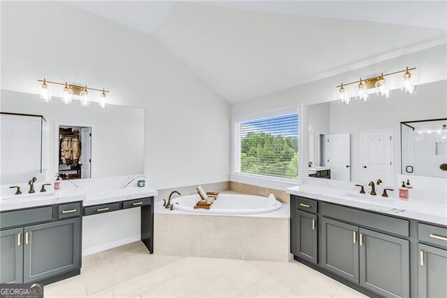 6150 Bridge Fair Rd, Cumming, GA 30028 - bathroom with a garden tub, lofted ceiling, two vanities, and tile patterned flooring