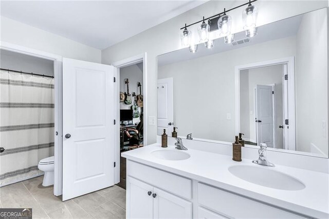 6150 Bridge Fair Rd, Cumming, GA 30028 - bathroom with double vanity, toilet, and tile patterned flooring