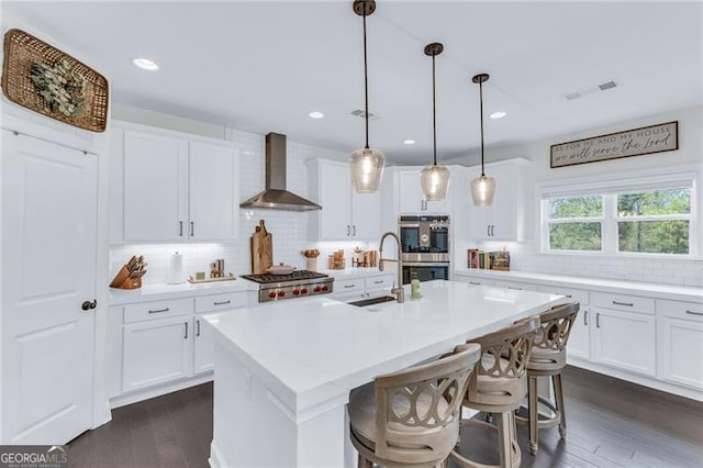 6150 Bridge Fair Rd, Cumming, GA 30028 - kitchen with wall chimney exhaust hood, a sink, decorative backsplash, stainless steel appliances, and dark wood-style flooring