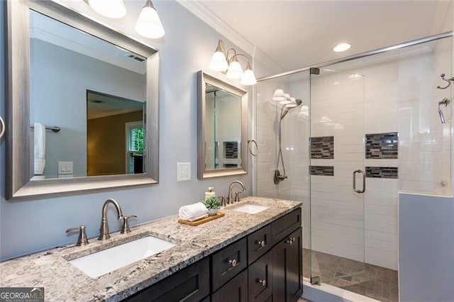 full bathroom featuring ornamental molding, a stall shower, and double vanity
