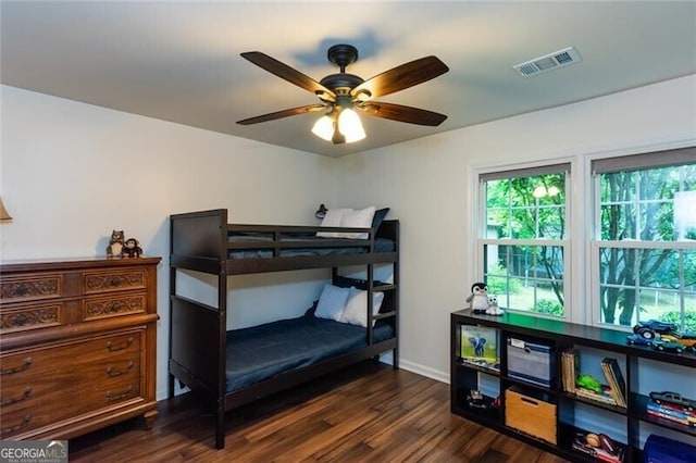 bedroom with dark wood-style flooring, baseboards, and a ceiling fan